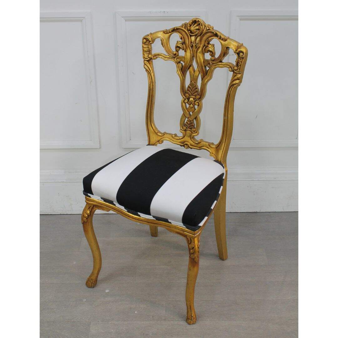 gold leaf chair with black and white stripes