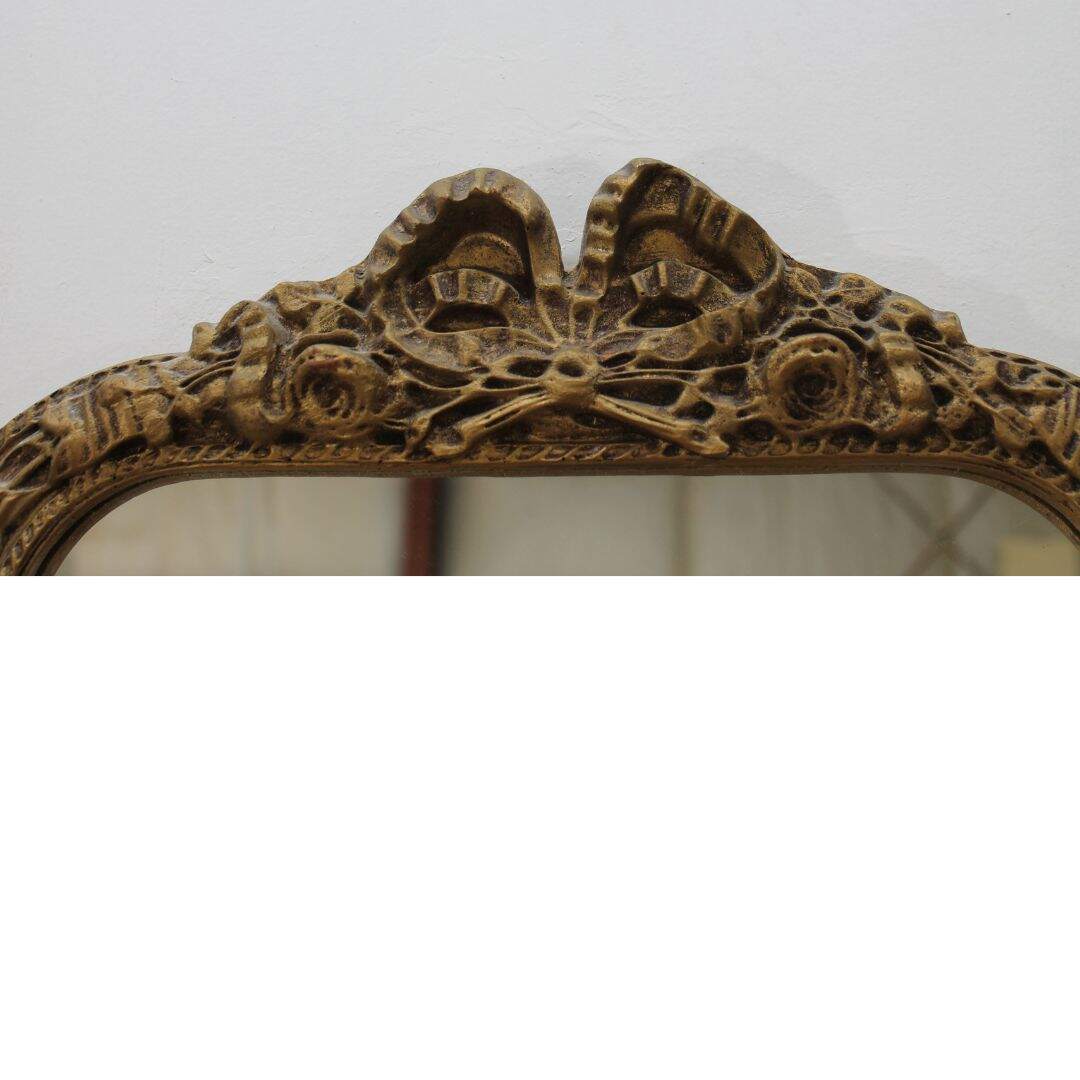 gold mirror with ribbon detail