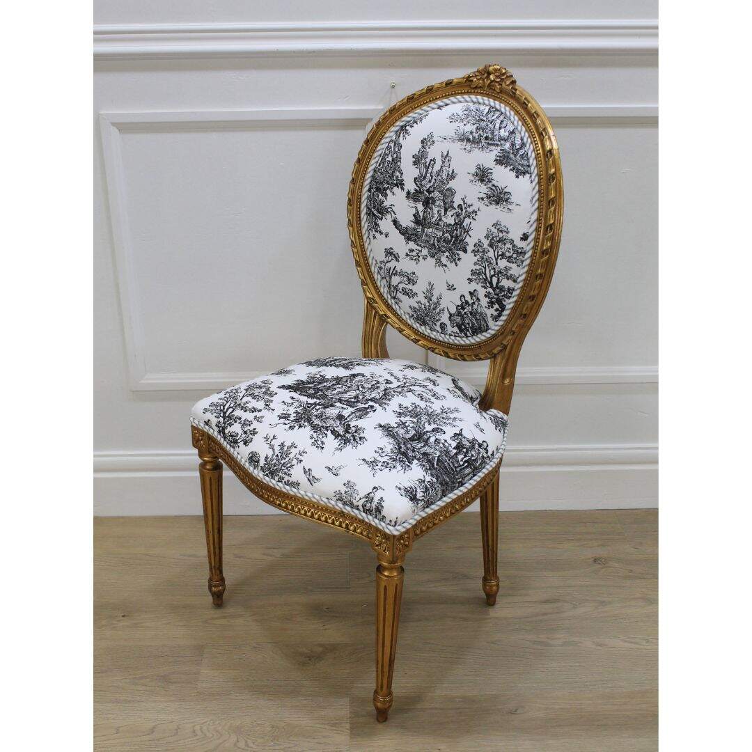 Pair of gold oval back French chairs with black and white toile
