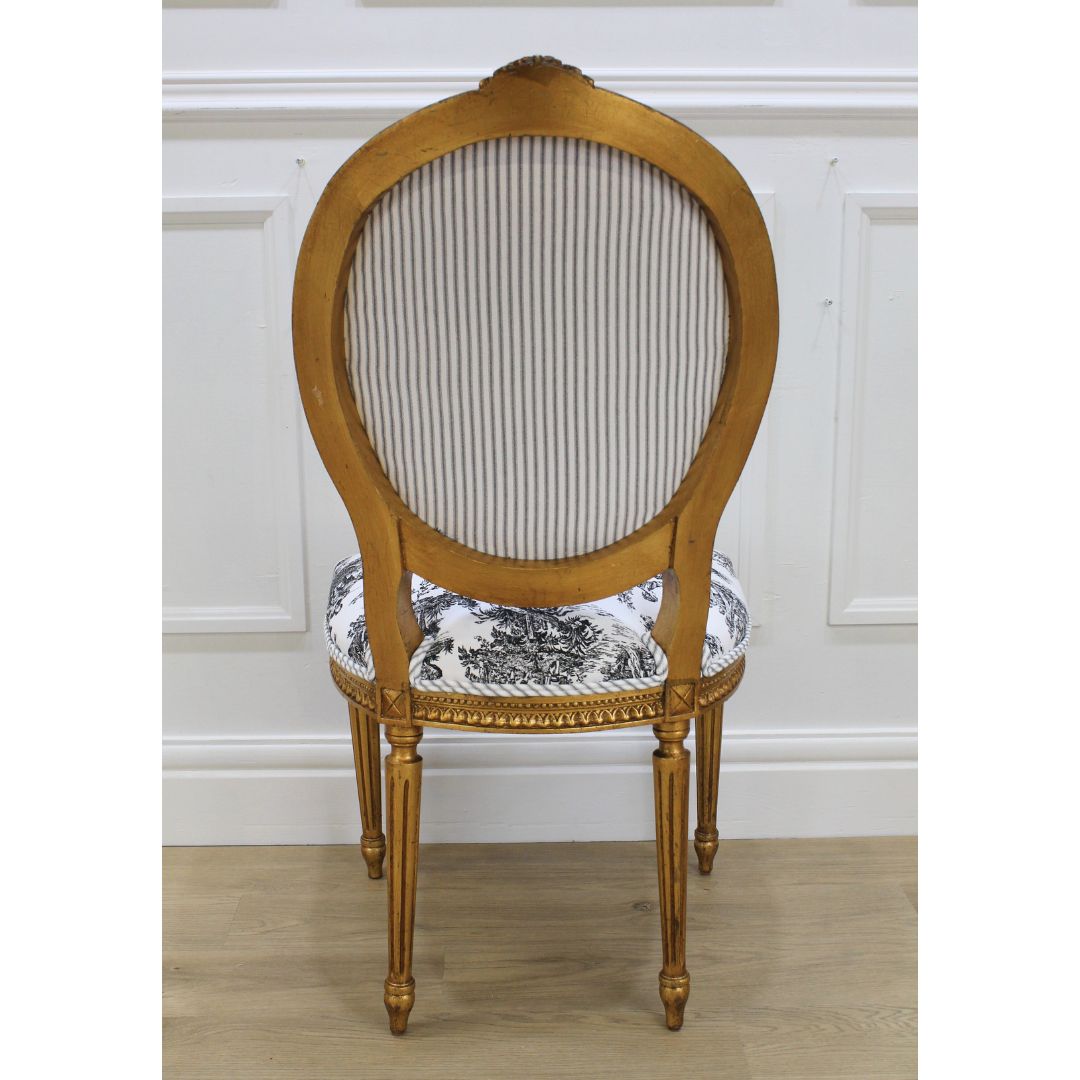 Pair of gold oval back French chairs with black and white toile