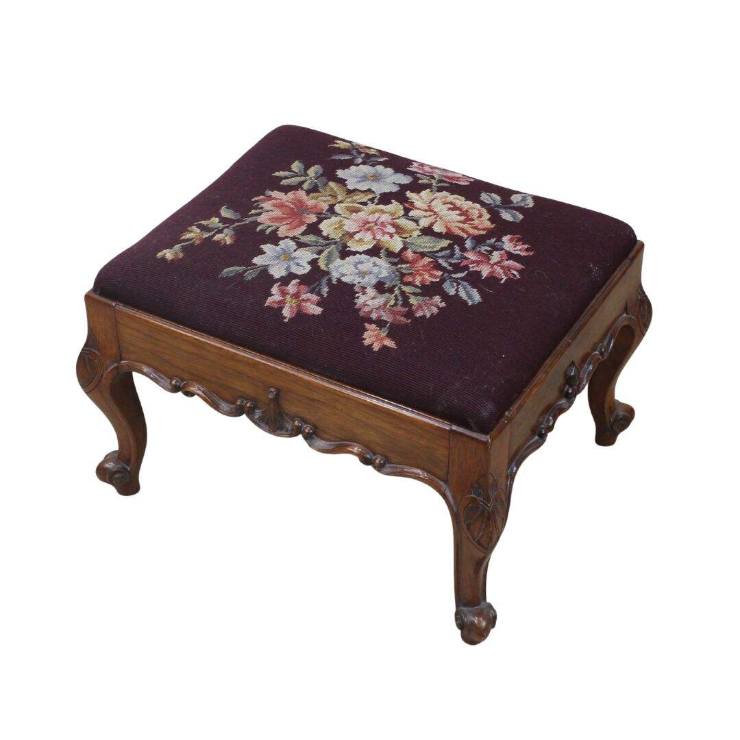 carved footstool with needlepoint