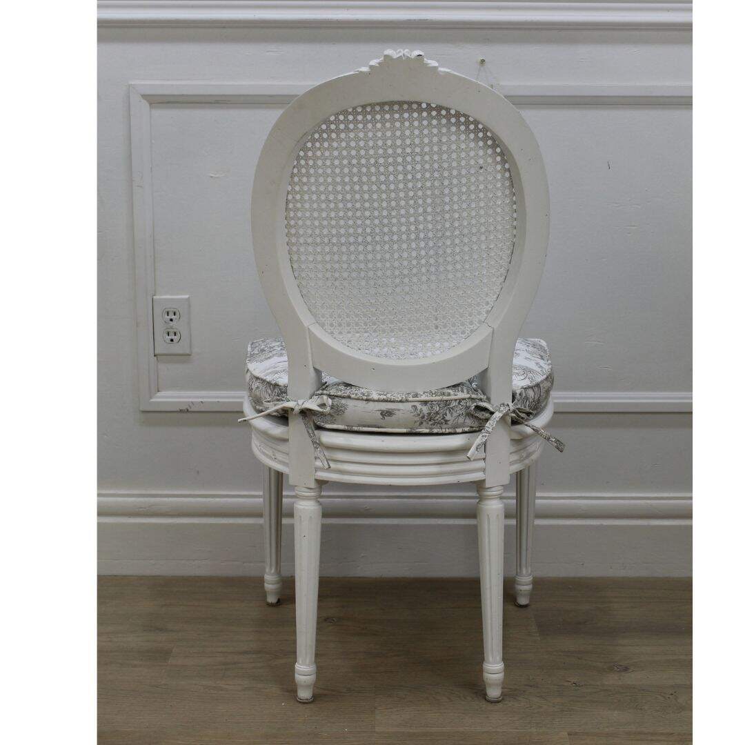 Oval back caned chair with toile cushion