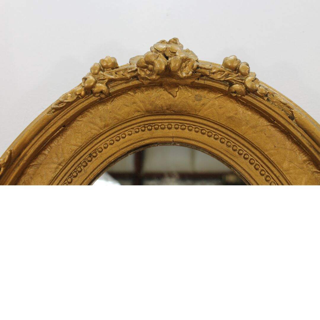 small oval mirror in antique frame