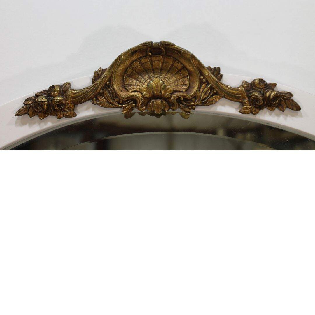Oval mirror with gold metal crest