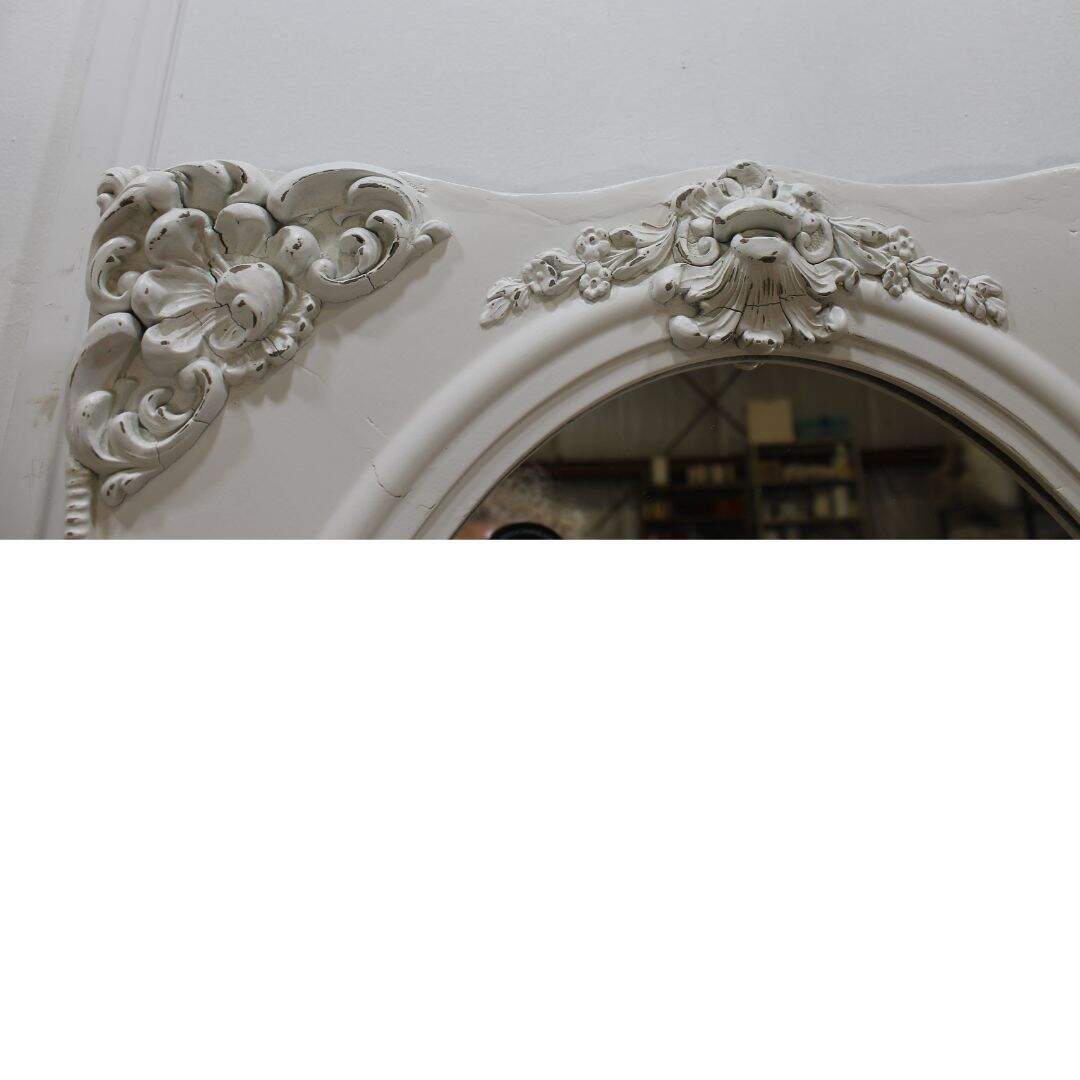 Oval mirror in ornate rectangular frame