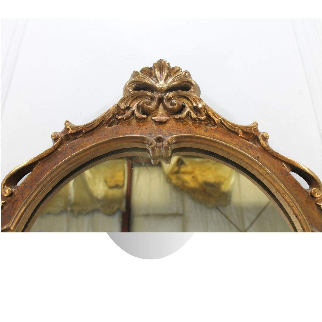 Oval gold ornate mirror