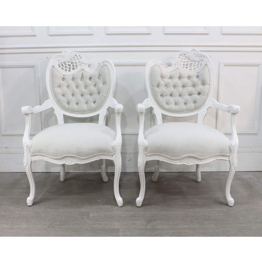 Pair of asymmetrical chairs with tufting