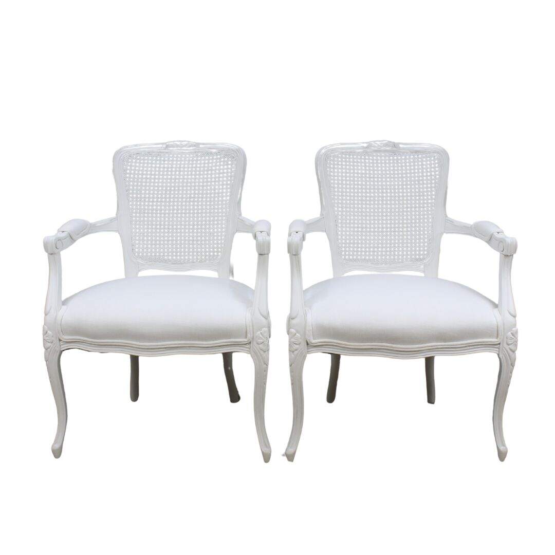 pair of white on white French chairs with caned backs