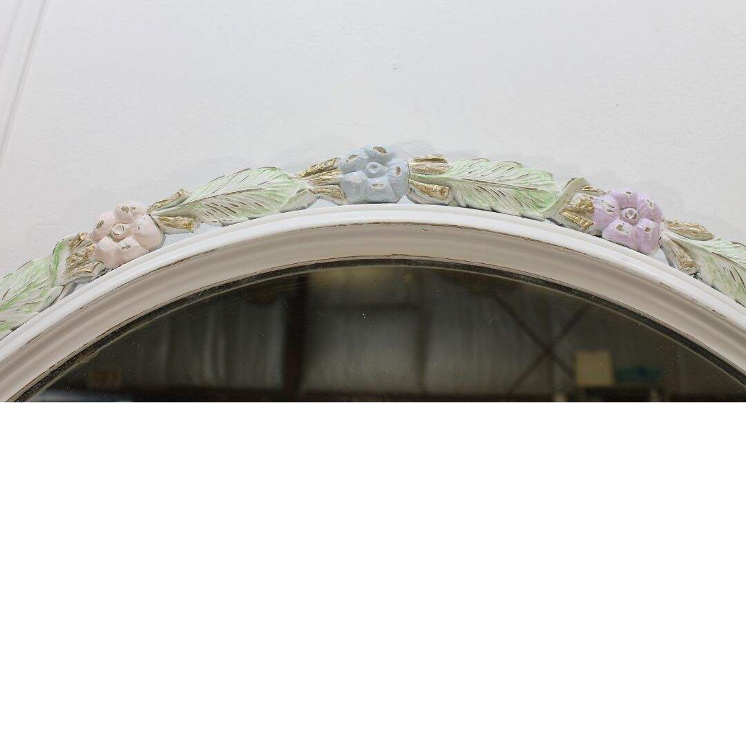 round mirror with pastel flower details