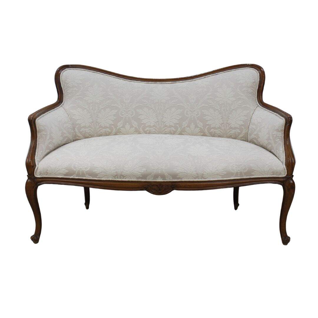 settee with carved curvy frame and beige fabric