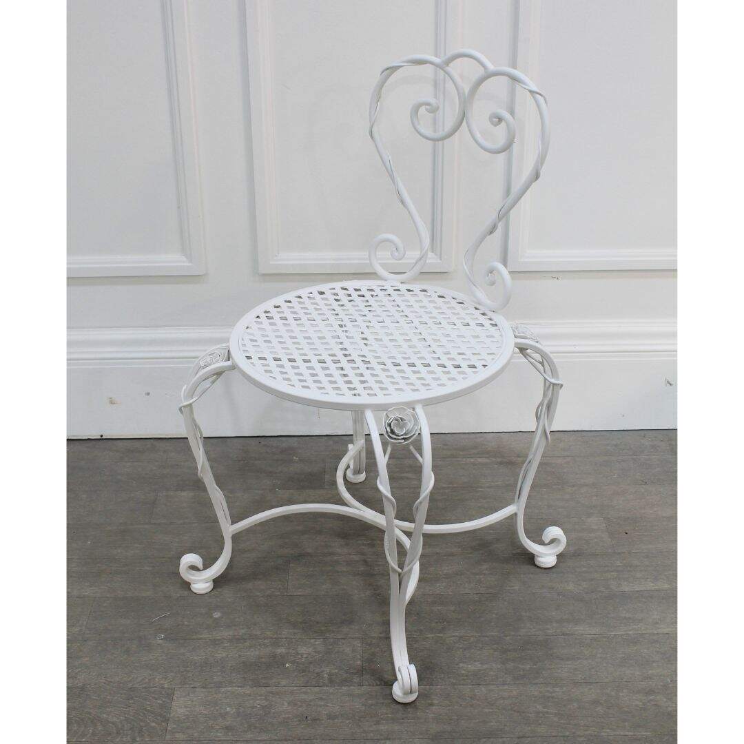 Ornate white wrought iron chair