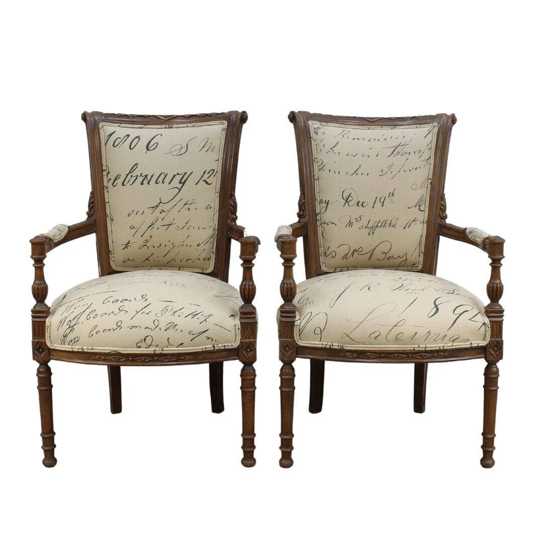 Pair of carved wood armchairs with script fabric